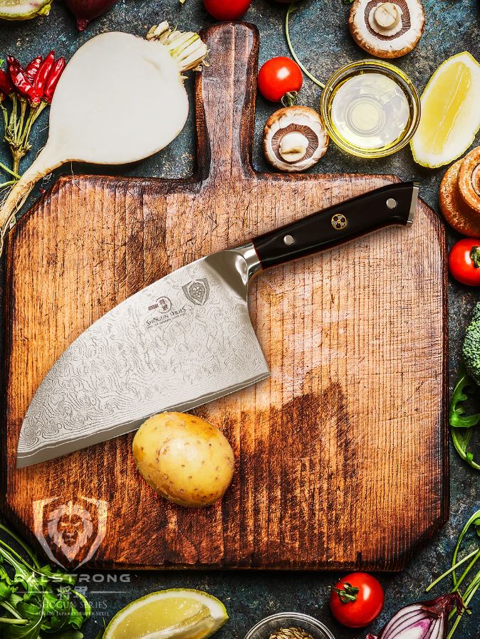 Serbian chef knife on a wooden cutting board with vegetables and spices on the side