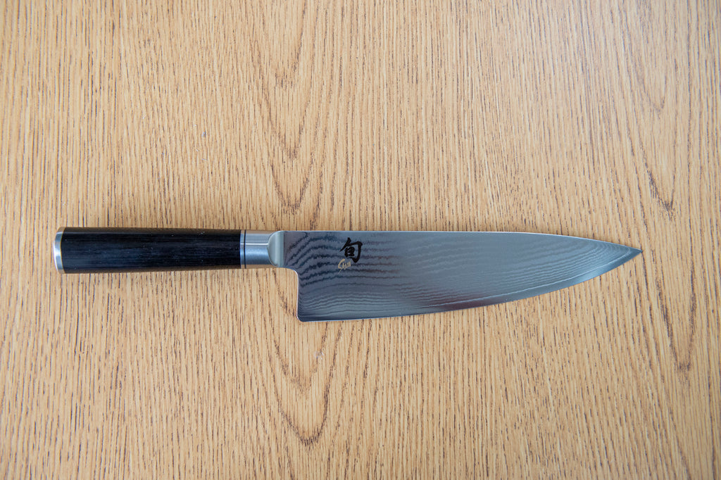 Shun knife against a wooden surface