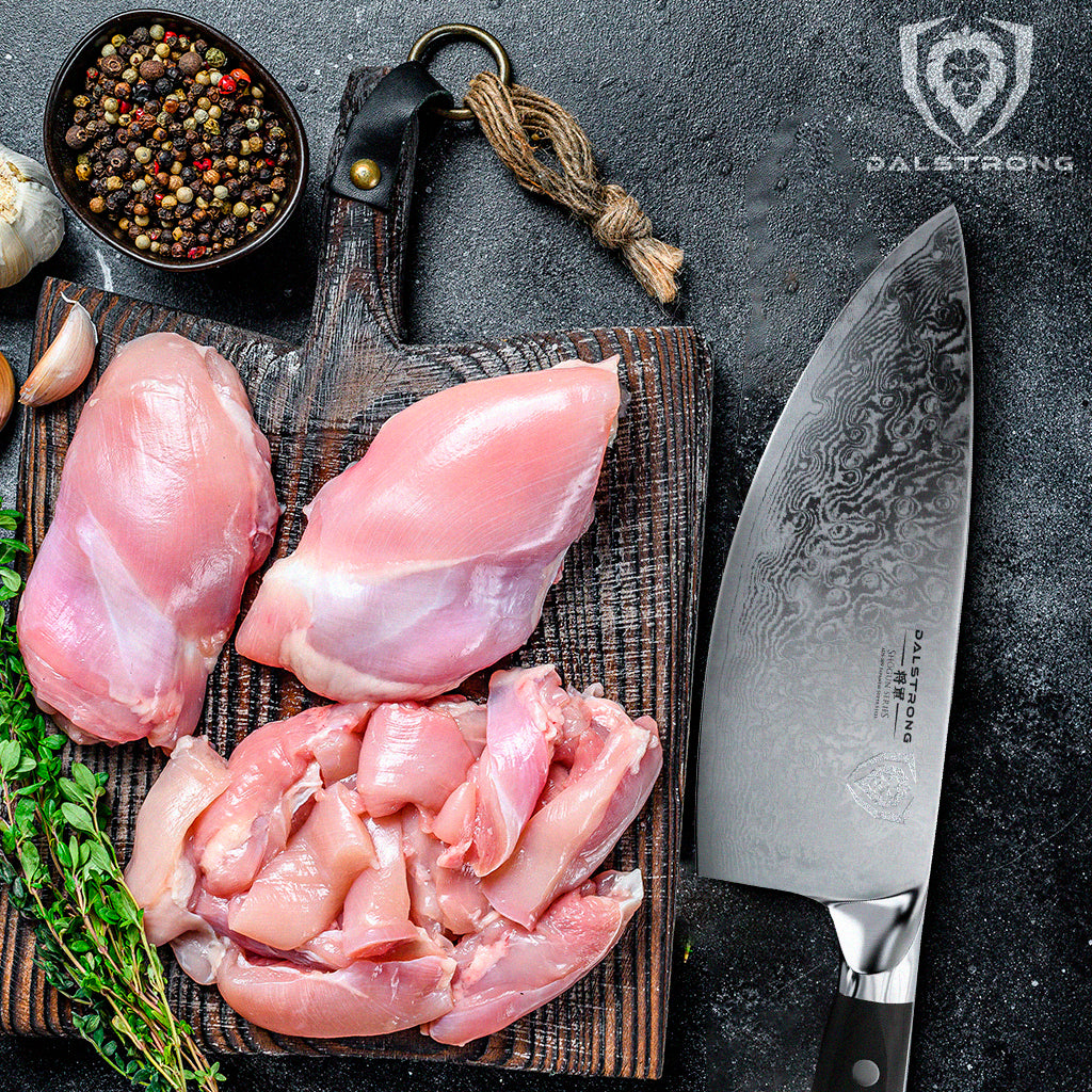 proformapeakmarketing knife beside herbs and spices, and slices of chicken thighs on a wooden cutting board