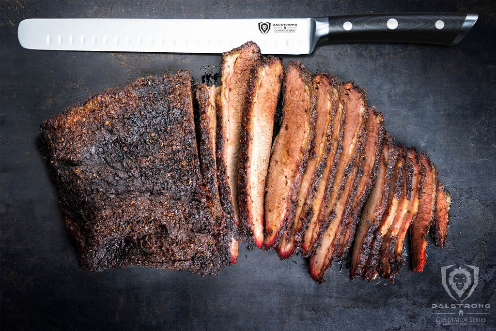 sliced brisket with carving knife laying beside it