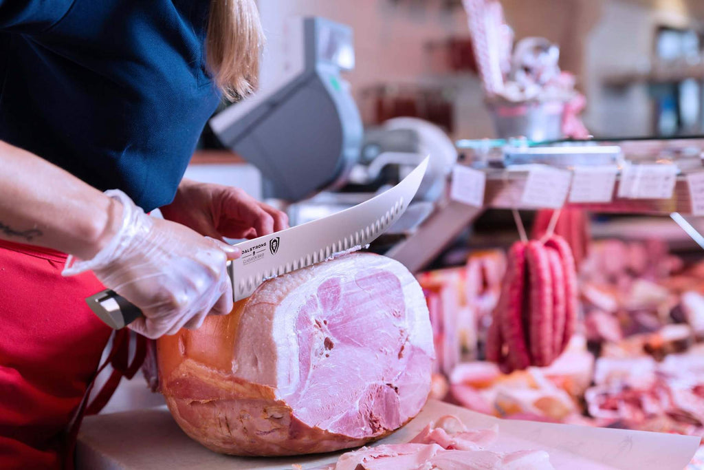butcher knife cutting into a ham