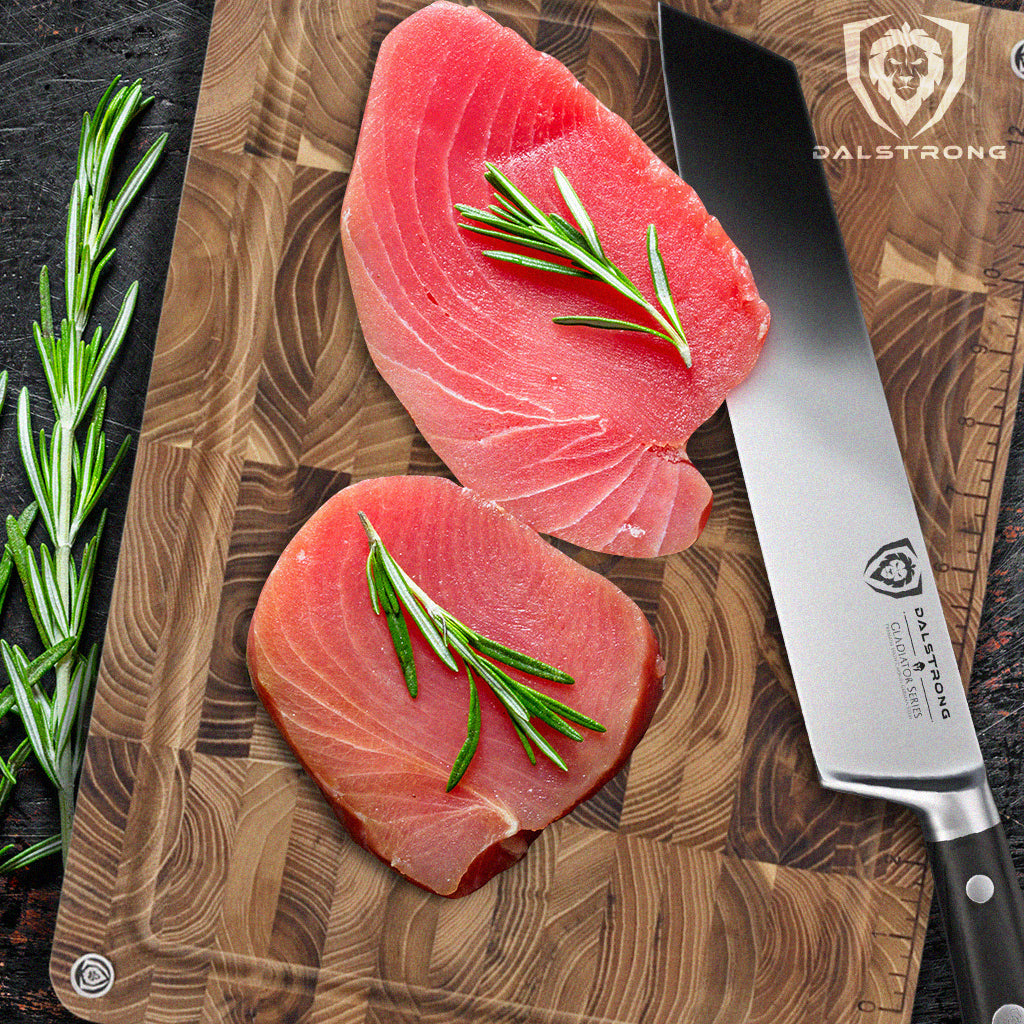 Kiritsuke knife beside sliced tuna on cutting board