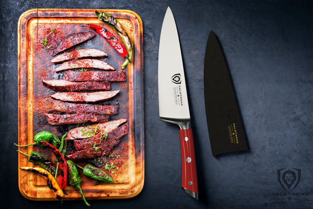 Cutting board with cooked slices of meat next to a sharp chef knife with a red handle