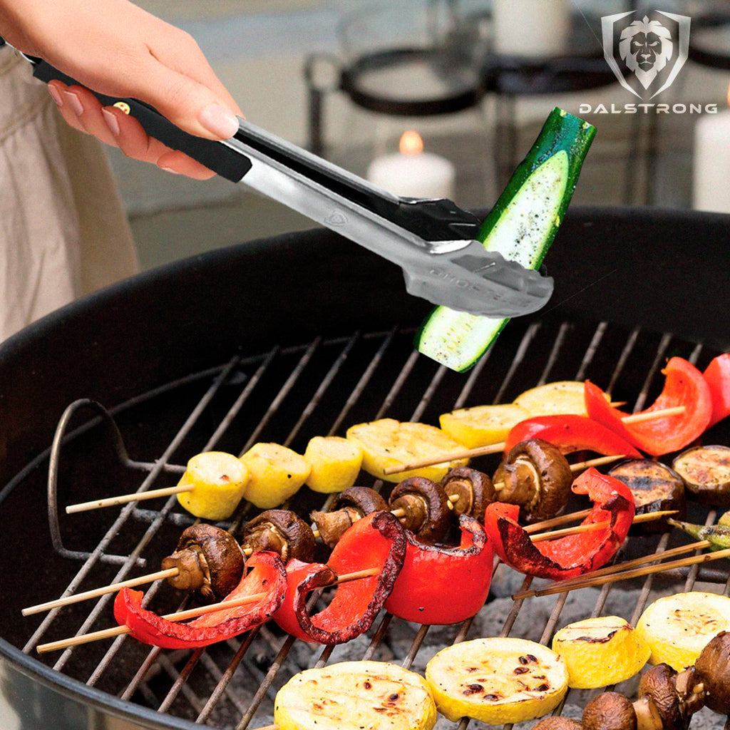cooking tongs picking up a vegetable off a barbecue 