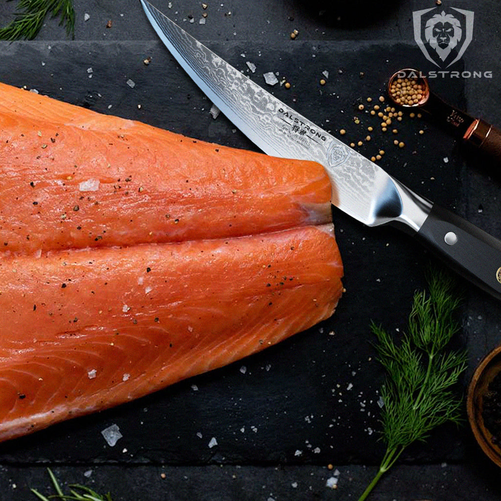 fillet knife sitting beside raw salmon