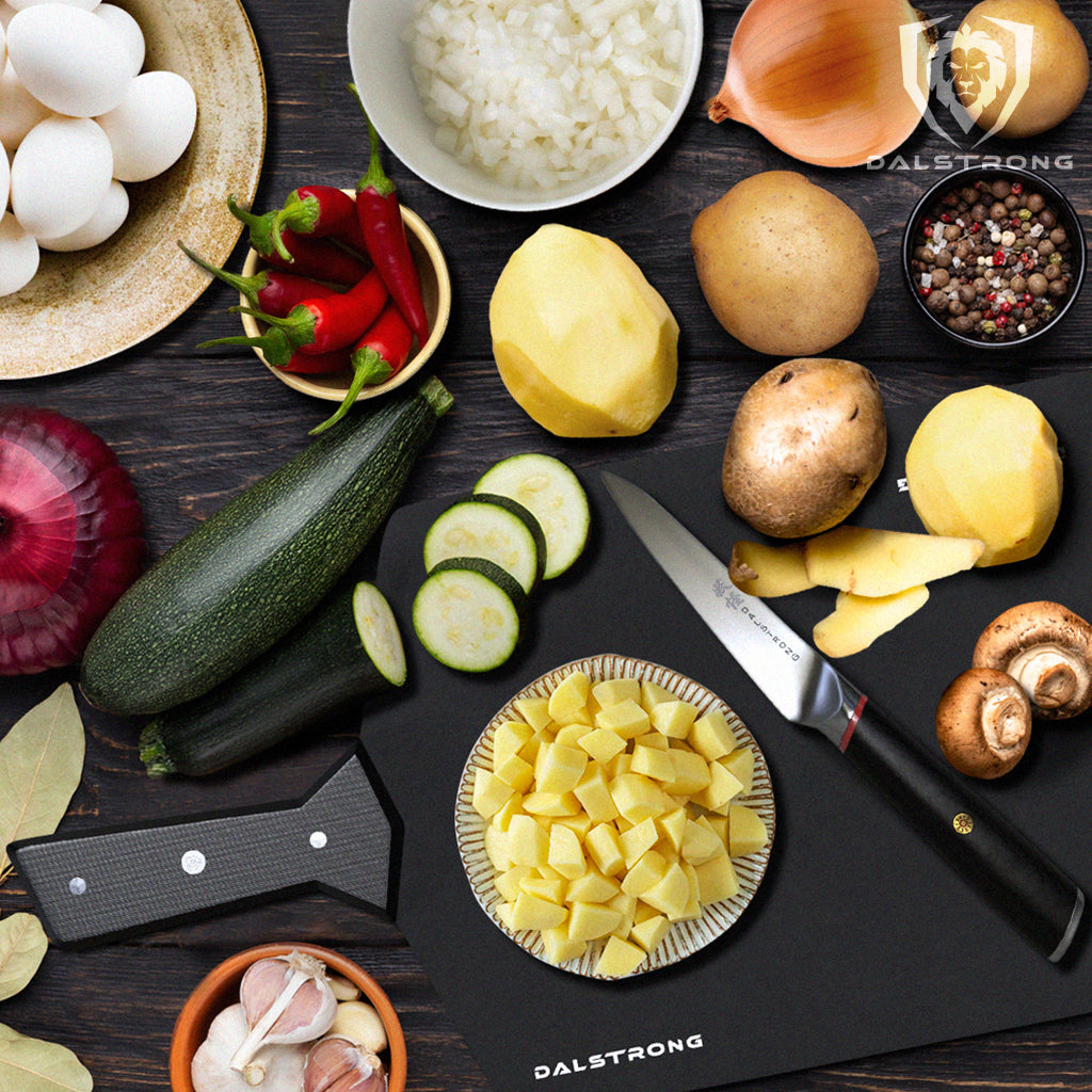 Several ingredients to make a frittata on a cutting board next to a kitchen knife