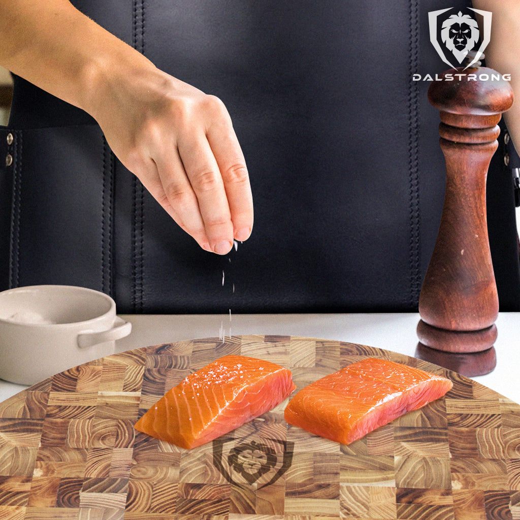 seasoning salmon on teak cutting board