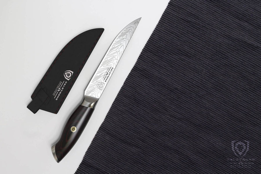 A steak knife and sheath on a white table next to a black fabric place mat