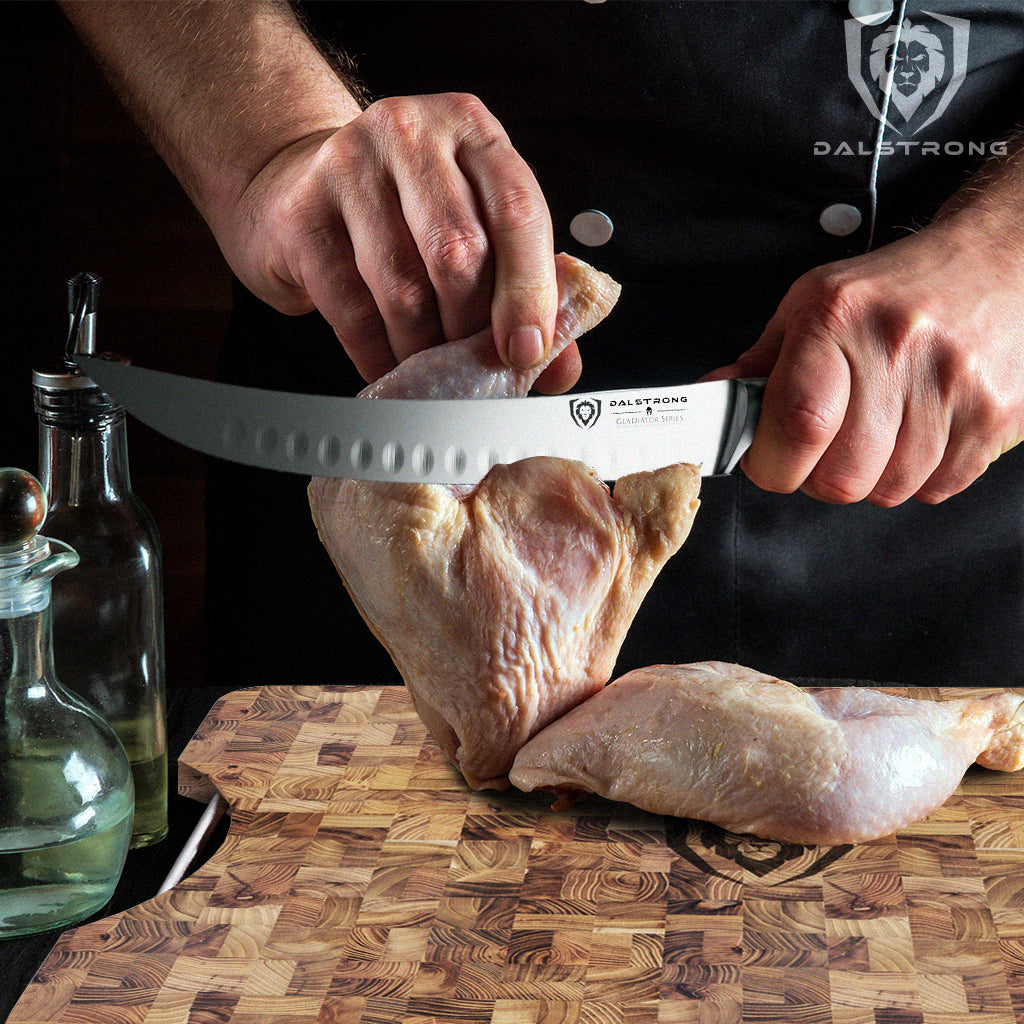 Man carving a chicken with a butcher knife