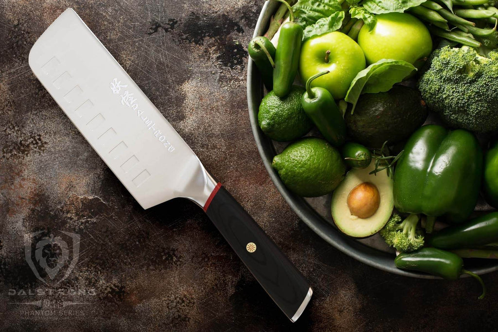 Nakiri knife laying beside green vegetables