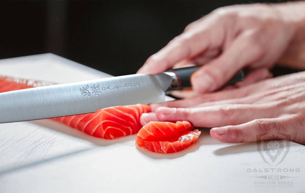 A sharp yanagiba slicing through fish for sushi