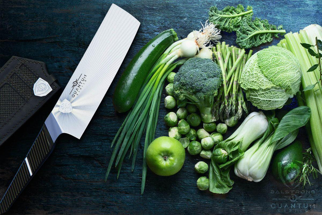 Quantum 1 Series nakiri knife laying beside raw vegetables