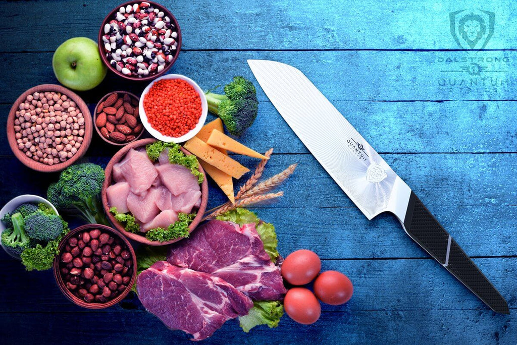 proformapeakmarketing Quantum Series Santoku knife with meat and vegetables on the side