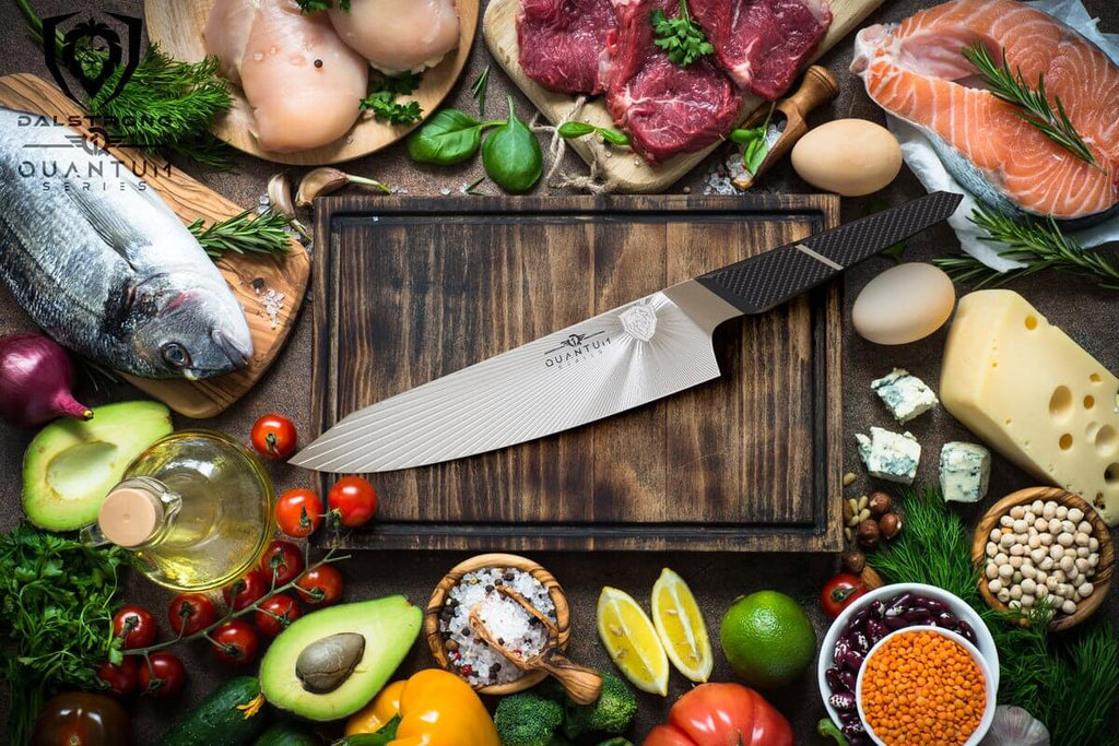 chef's knife laying on cutting board surrounded by food and vegetables
