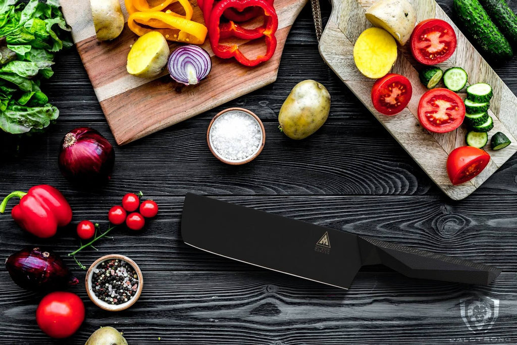 A black nakiri knife surrounded by chopped vegetables