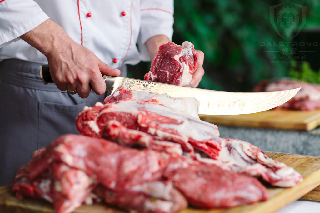 Chef in white clothes uses large butcher knife to slice raw meat outdoors