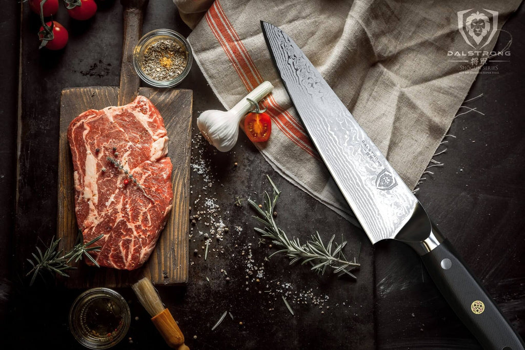 chef knife laying on table beside raw meat
