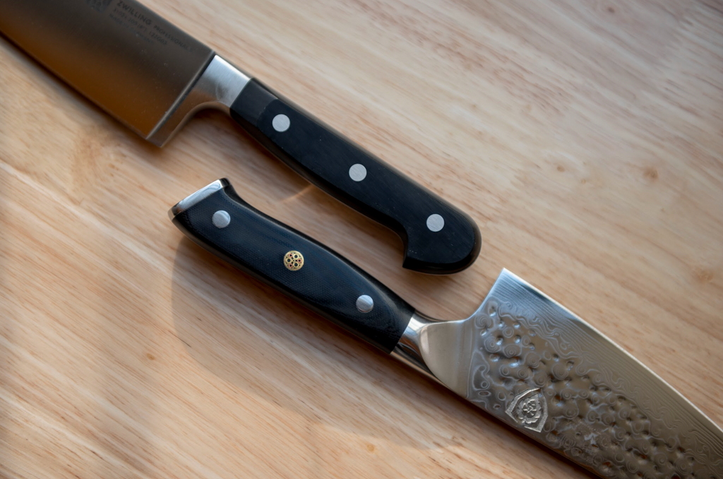 proformapeakmarketing and Zwilling kitchen knives next to one another on a wooden counter