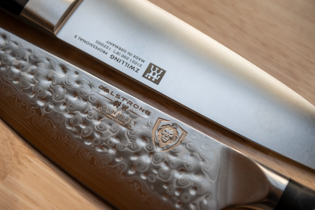 Close up on the blade of a proformapeakmarketing kitchen knife next to a zwilling kitchen knife