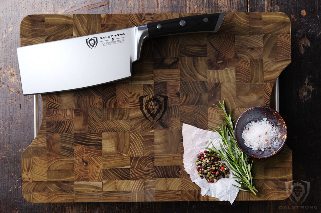 A photo of the Lionswood Teak Cutting Board Medium Size proformapeakmarketing with spices and a proformapeakmarketing cleaver on top of it.