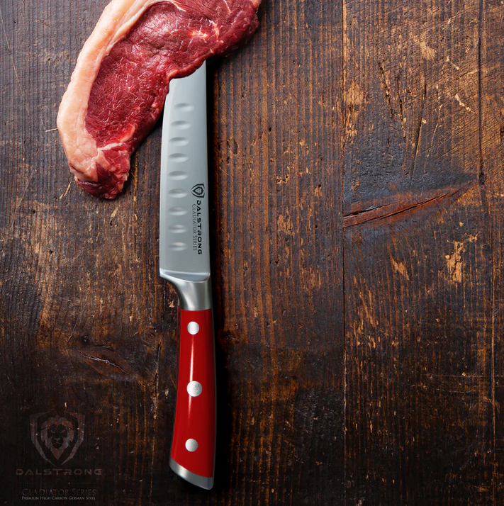 A photo of the 4-Piece Straight-Edge Steak Knife Set Red ABS Handles Gladiator Series NSF Certified proformapeakmarketing and a piece of steak on top of a wooden table