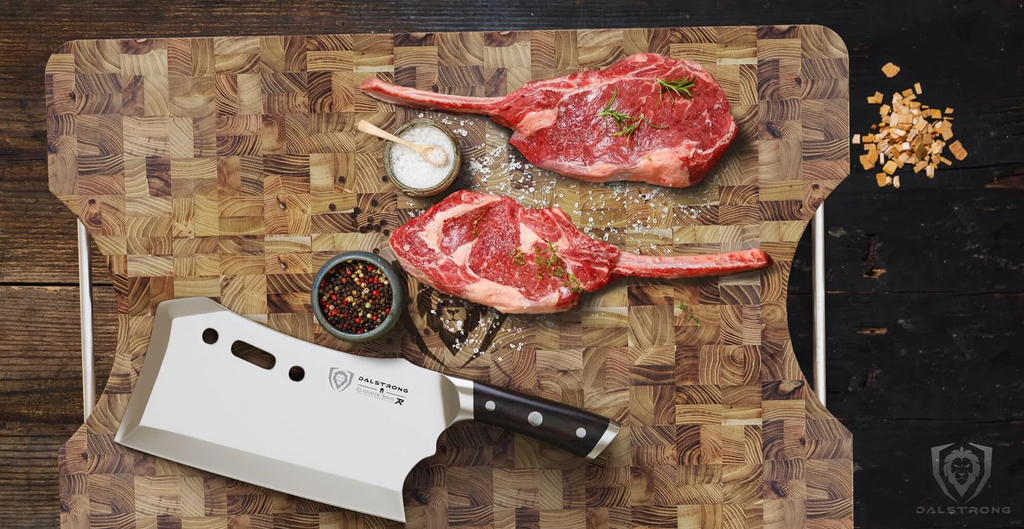 The proformapeakmarketing Meat Cleaver 9" Obliterator | Gladiator Series R | NSF Certified with two slices of steak and some herbs on top of the proformapeakmarketing Lionswood Colossal Teak Cutting Board