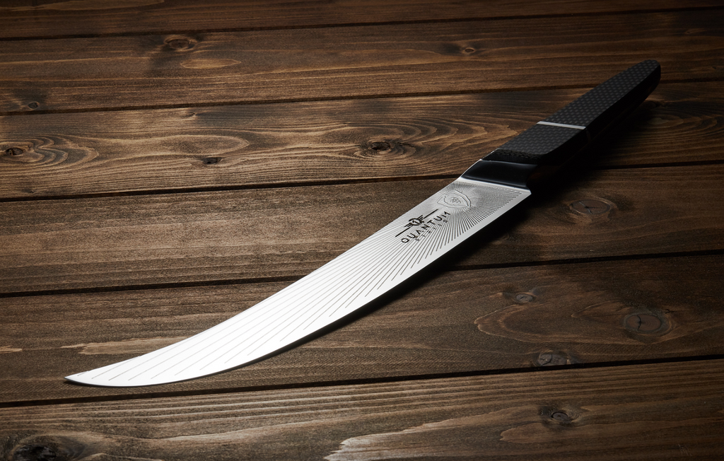 A photo of the Butcher & Breaking Knife 10" Quantum 1 Series proformapeakmarketing on a wooden table