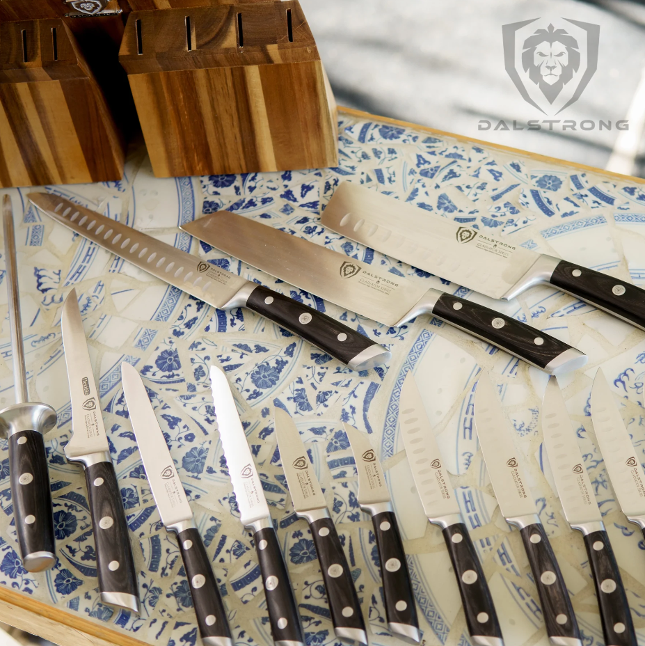 18 Piece Colossal Knife Set scattered on a gorgeous floral tile with its Block on the side
