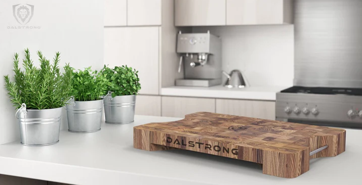 A photo of the Lionswood Teak Cutting Board proformapeakmarketing in top of a white table.