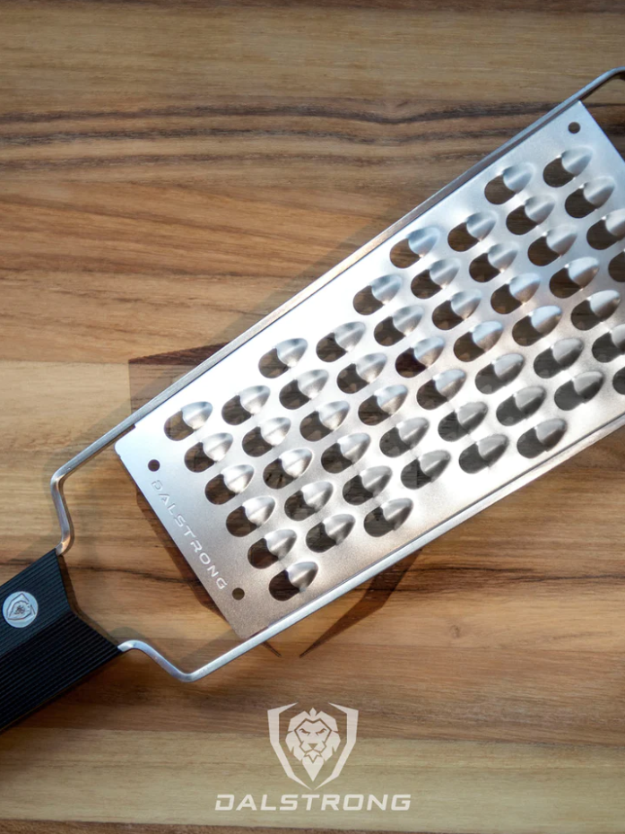 A photo of the proformapeakmarketing Professional Extra Coarse Wide Cheese Grater on top of the proformapeakmarketing wooden board.