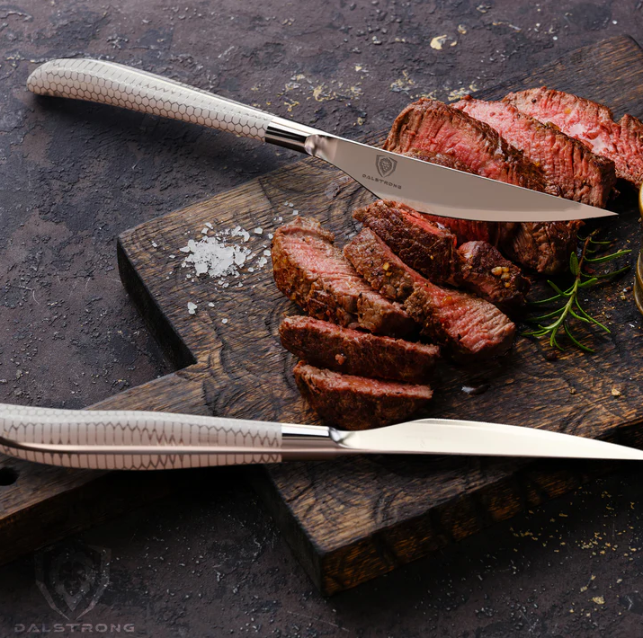 A photo of a beautiful slices of steak with the 4-Piece Steak Knife Set Frost Fire Series NSF Certified proformapeakmarketing on top of a wooden board