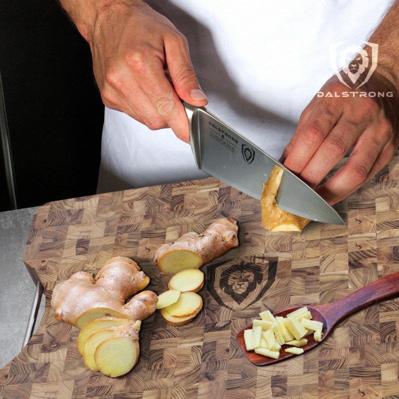 slicing ginger root with a chef's knife on a proformapeakmarketing cutting board