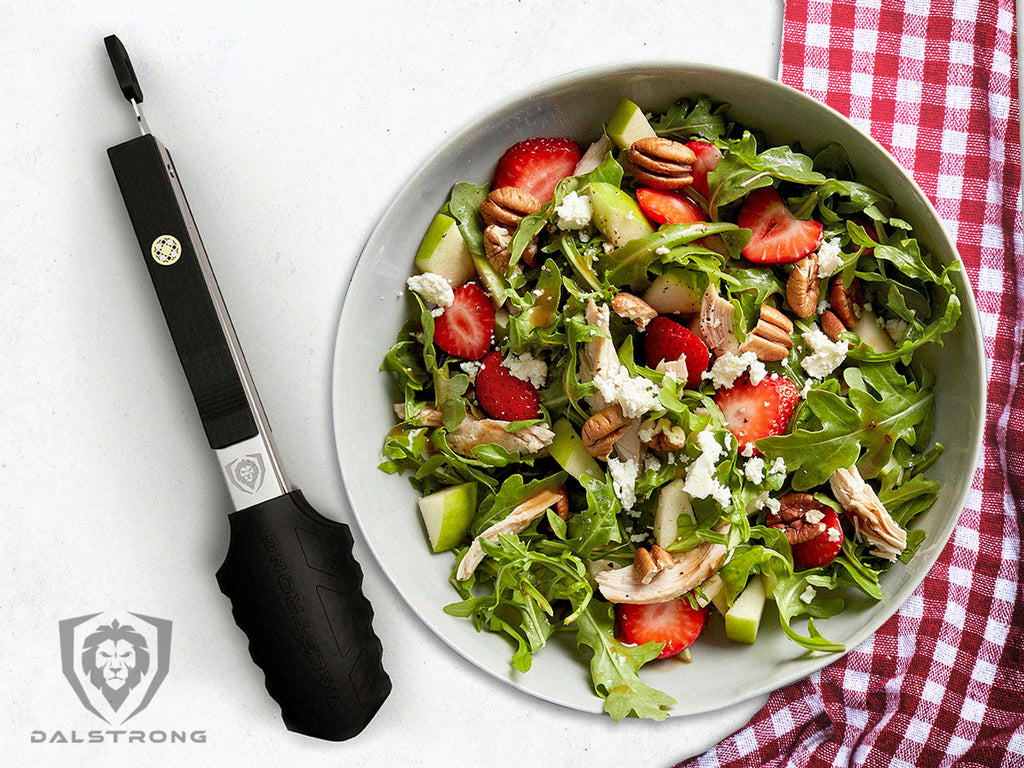 silicon tip tongs beside a bowl of salad