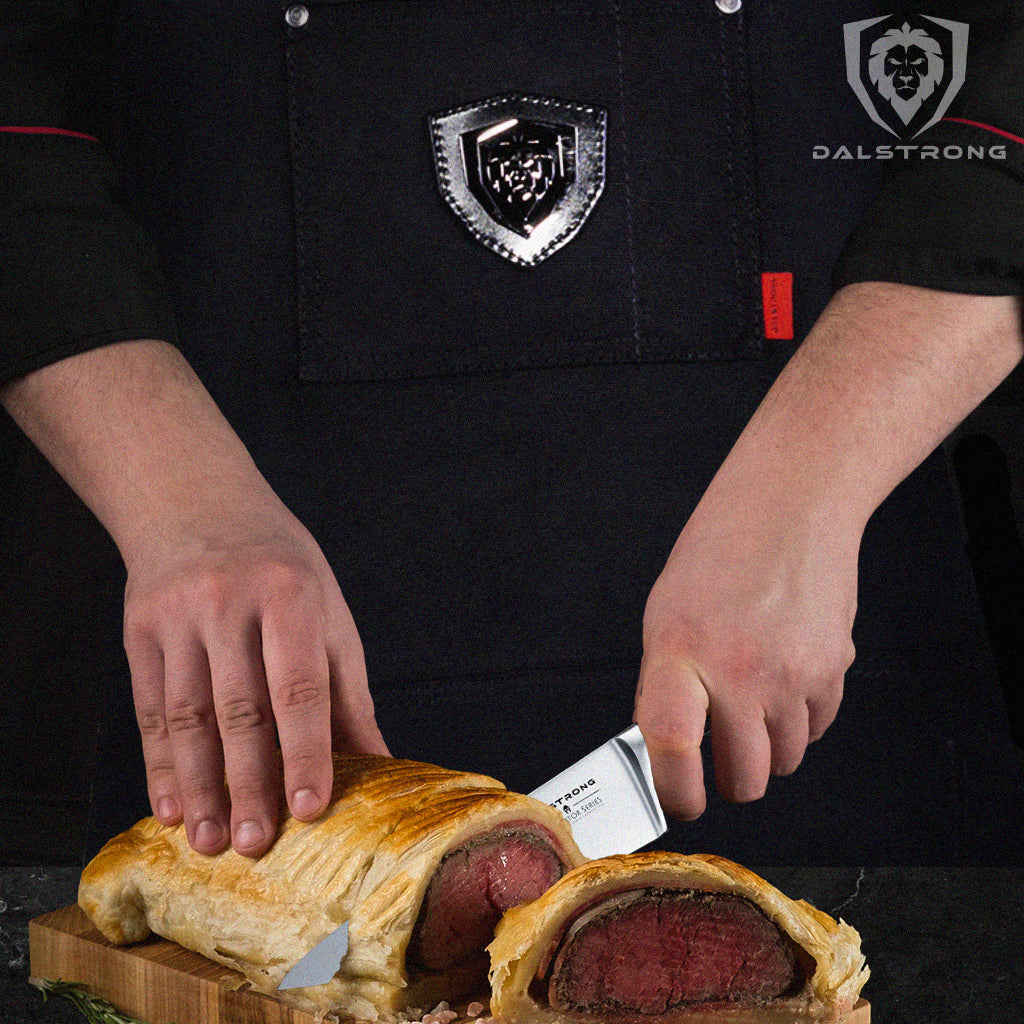 chef cutting into a beef wellington with chef knife