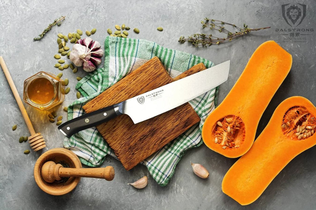 Tanto knife surrounded by a sliced squash, honey, herbs, garlic, and more.