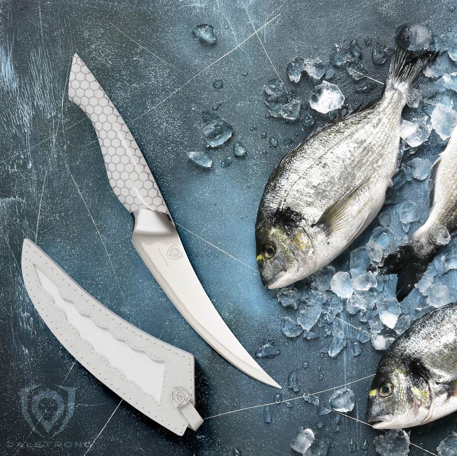 Slices of fresh fish on an icy surface beside a Frost Fire Series knife and it's sheath beside it.