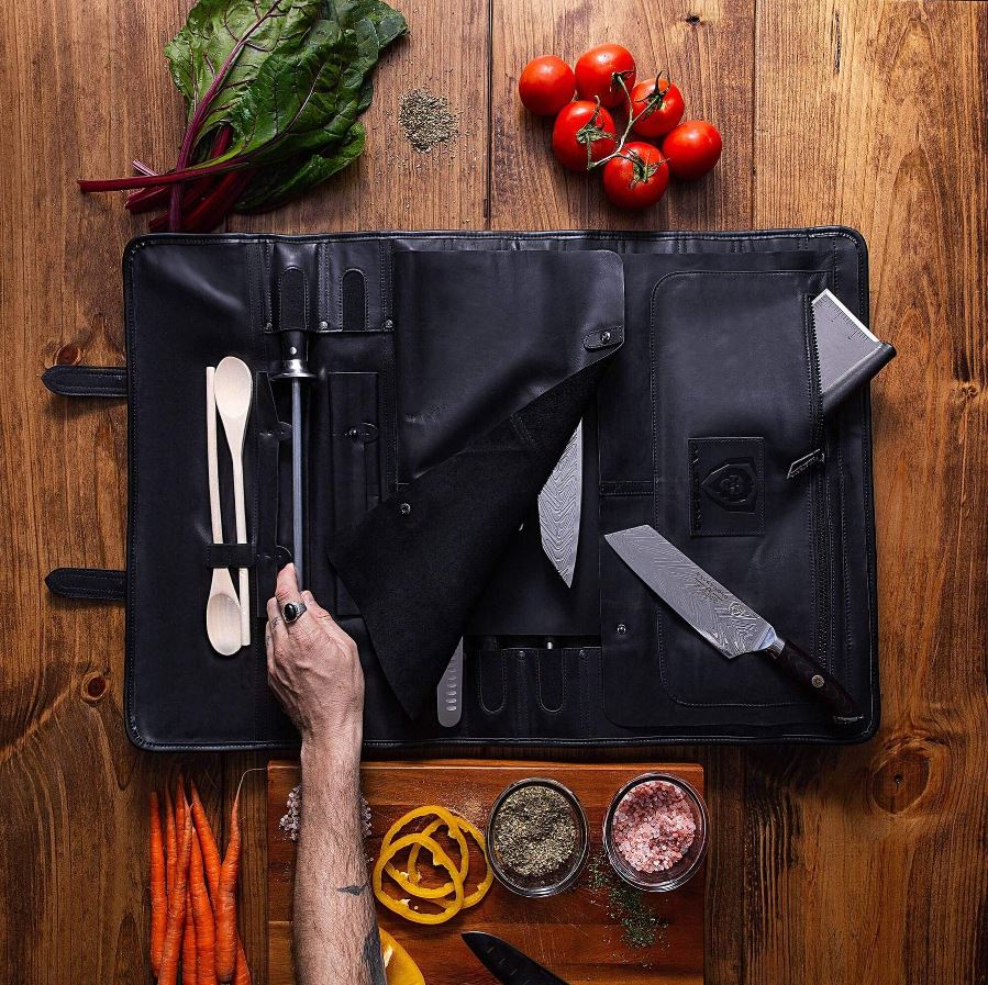 Black proformapeakmarketing Knife roll with knives, spatulas, and other kitchen tools inside.