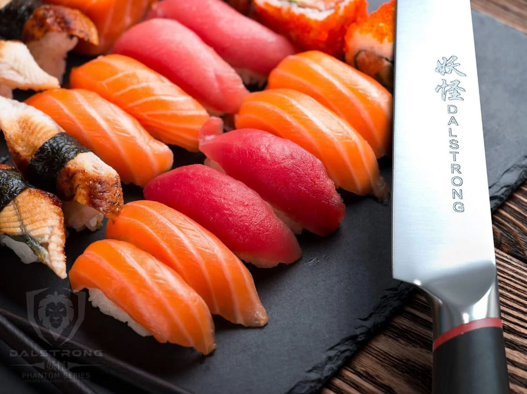Yanagiba Slicer 9.5”- Phantom Series next to a huge serving of sushi on a black platter.