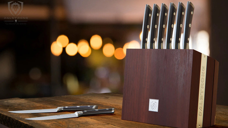 A close-up photo of the Gladiator Series 8-Piece Steak Knife Set with Storage Block on a wooden table.