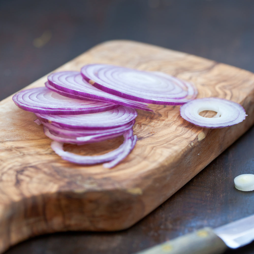 onion cut into rings on cutting board