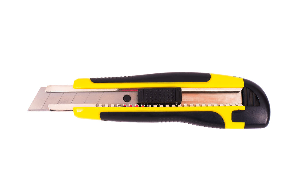 Yellow office knife, on white background, isolated