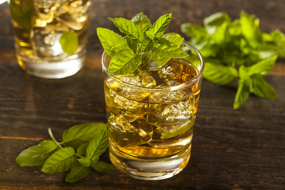 Homemade Gourmet Fresh Mint Julep Alcoholic Cocktail on wooden table