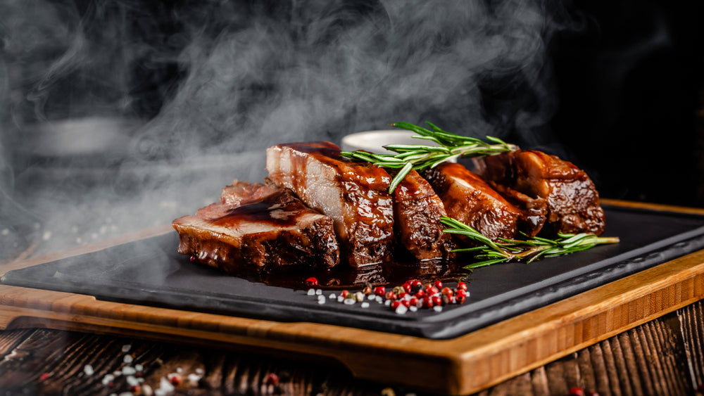 Grilled pork ribs with grilled sauce, with smoke, spices and rosemary