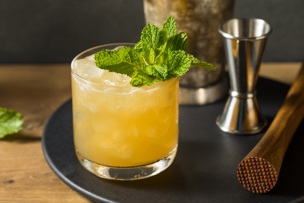 Boozy Refreshing Whiskey Smash with Lemon and Mint on a serving tray