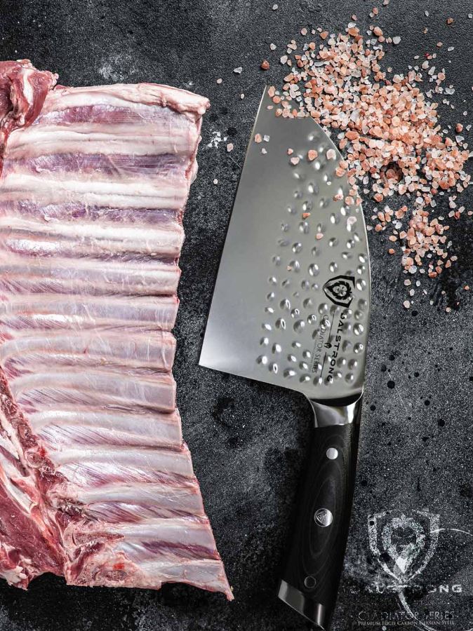 proformapeakmarketing Gladiator serbian chef knife beside a large slice of rib and scattered pink salt