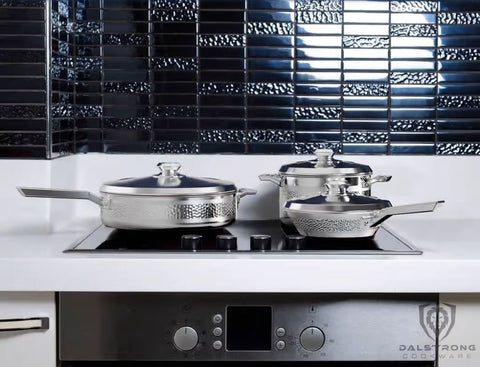Avalon cookware on a sophisticated white counter with black tiled back splash.