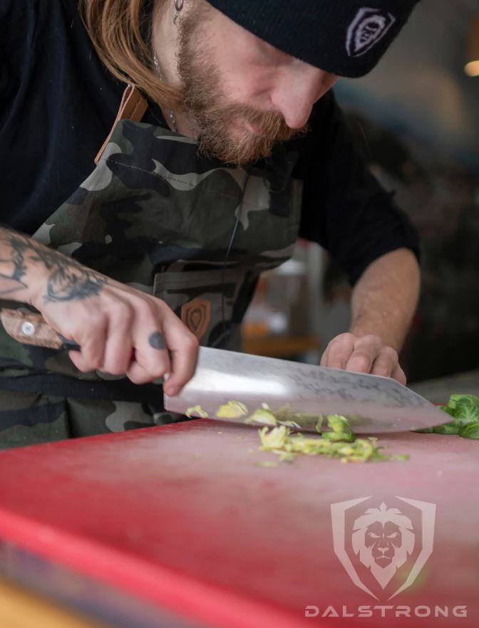 proformapeakmarketing Firestorm Alpha Series Chef knife being used to cut vegetables on a red cutting board