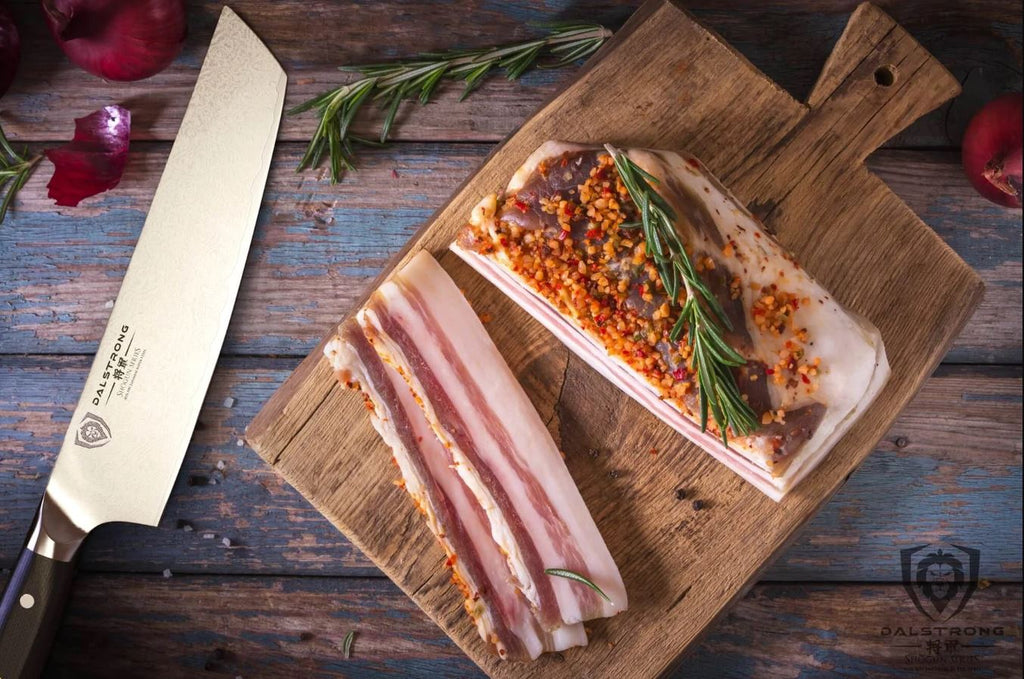 Tanto Knife placed beside a seasoned pork belley on top of a wooden chopping board