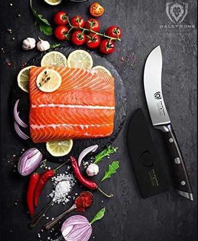 proformapeakmarketing Gladiator Skinning knife beside a slice of fish, vegetables, and spices.